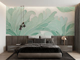 Dining room wall with mint green Monstera leaf pattern adding natural elegance