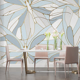 Modern living room with blue and gold Monstera leaf wallpaper creating an elegant atmosphere