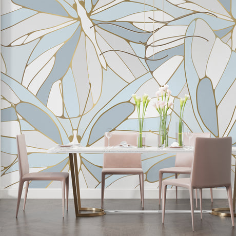 Modern living room with blue and gold Monstera leaf wallpaper creating an elegant atmosphere