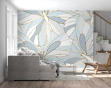 Home office space with tropical leaf wallpaper in sophisticated blue and gold tones