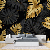 Black and gold tropical wallpaper making a statement in an elegant dining room setting