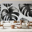 Modern dining room with Black and White Monstera Leaf Wallpaper creating dramatic contrast against minimalist furniture
