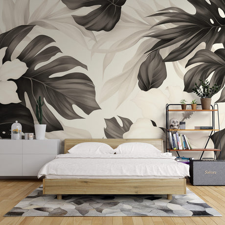 Black and white Monstera leaf wallpaper creating a stunning focal point in a modern living room with natural light