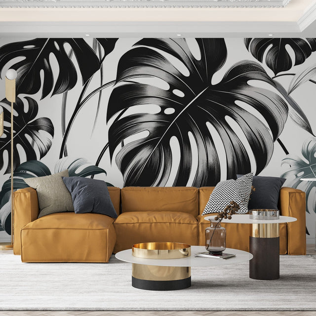 Modern living room with black and white Monstera leaf wallpaper creating dramatic impact against neutral furniture