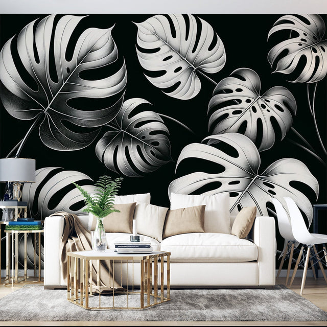 Modern living room with Black and White Monstera Leaf Wallpaper creating a stunning feature wall behind grey sofa
