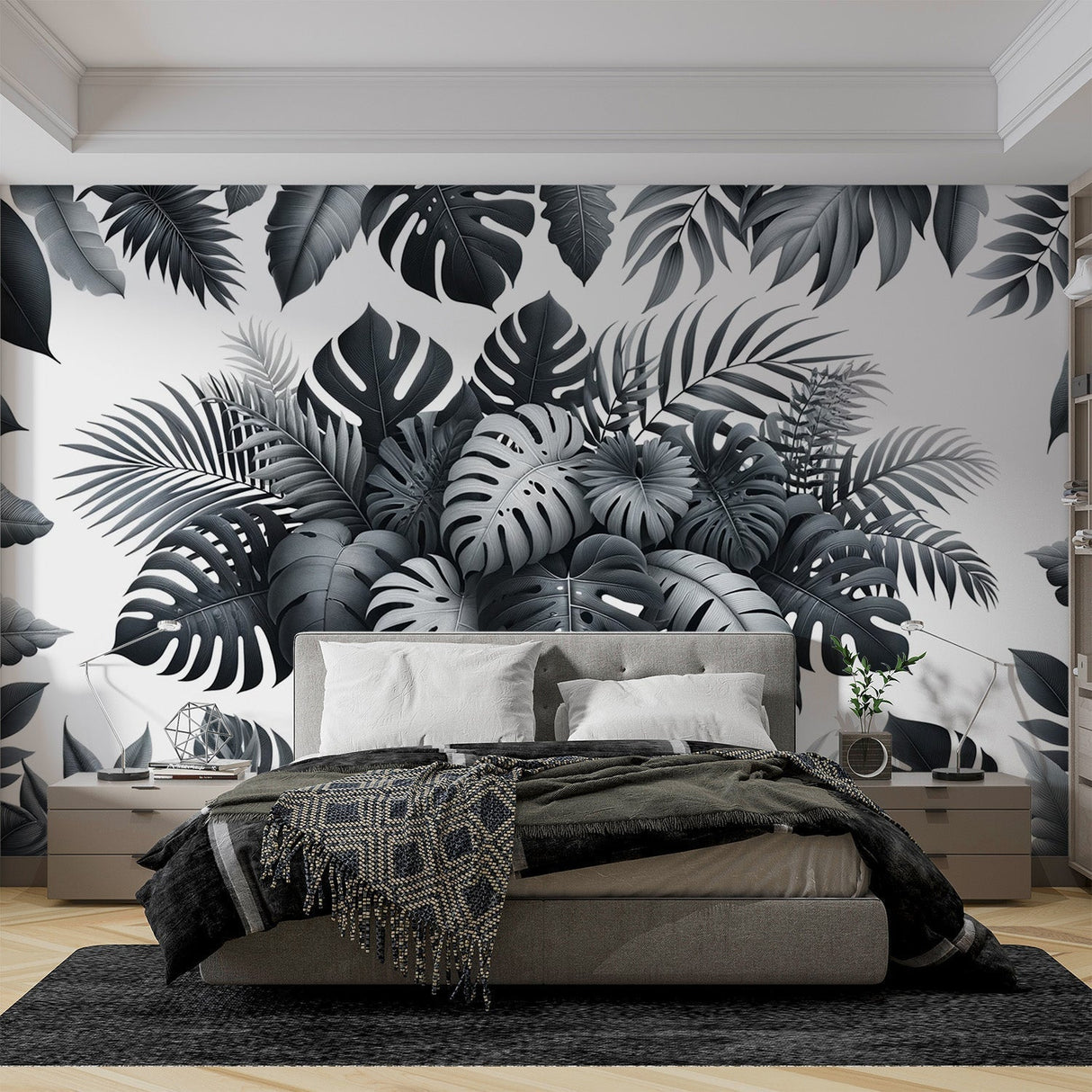 Modern black and white Monstera leaf wallpaper creating a stunning accent wall in a bright, minimal living room setting