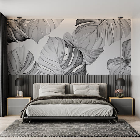 Modern Monstera leaf wallpaper in a bright Scandinavian living room showing the dramatic black and white pattern