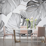 Tropical leaf wallpaper installation in a contemporary home office space