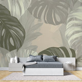 Monstera leaf wallpaper creating a fresh vibe in a modern living room with white furniture