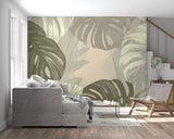 Botanical wall mural with monstera leaves in a home office setting with natural light