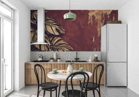 Luxury Monstera leaf wallpaper in modern dining room, golden leaves catching evening light against burgundy background
