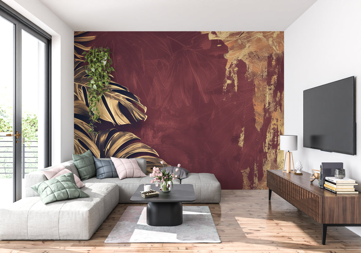 Tropical wall mural bringing warmth to hallway with golden monstera leaves on deep burgundy