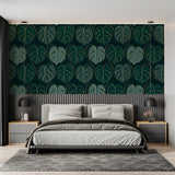 Monstera leaf wallpaper in modern living room showing green and gold pattern catching natural light