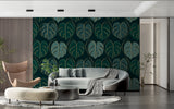 Green and gold monstera wallpaper creating depth in dining room setting