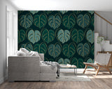 Botanical wall mural featuring monstera leaves in bedroom setting
