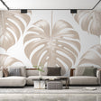 Monstera leaf wallpaper creating an elegant atmosphere in a modern living room with natural light highlighting the beige pattern