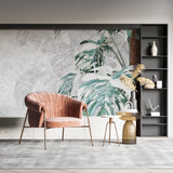 Dining room showcasing green Monstera wallpaper with sophisticated marble details