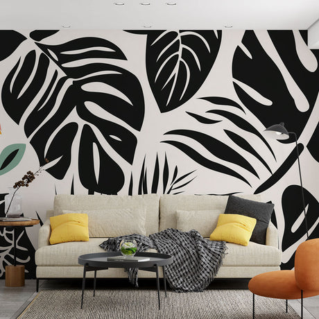 Modern black and white Monstera leaf wallpaper creating a bold statement in a minimalist living room setting