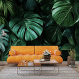 Monstera leaf wallpaper creating a bold statement in a modern living room with minimalist furniture