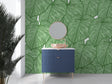 Modern living room with Monstera leaf wallpaper creating a fresh tropical atmosphere