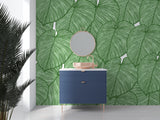 Modern living room with Monstera leaf wallpaper creating a fresh tropical atmosphere
