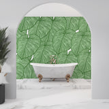Home office featuring botanical Monstera wallpaper bringing nature indoors
