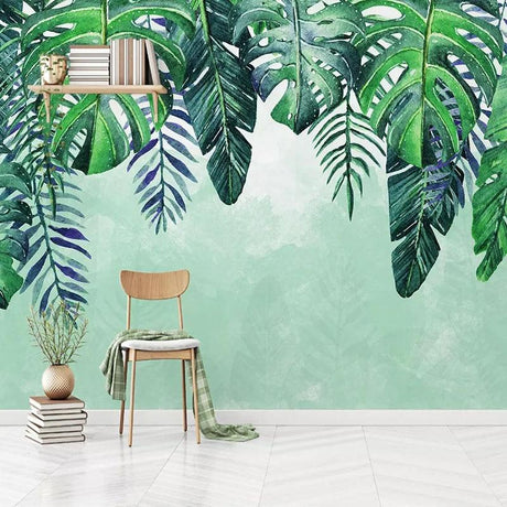 Monstera leaf wallpaper creating a fresh vibe in a modern living room with white furniture