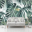 Monstera leaf wallpaper in bright modern living room with white sofa and natural light