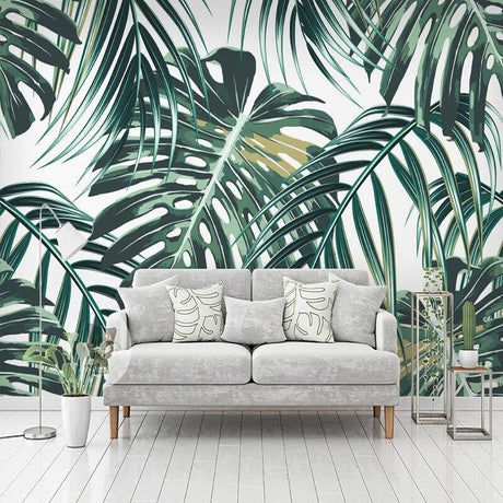 Monstera leaf wallpaper in bright modern living room with white sofa and natural light