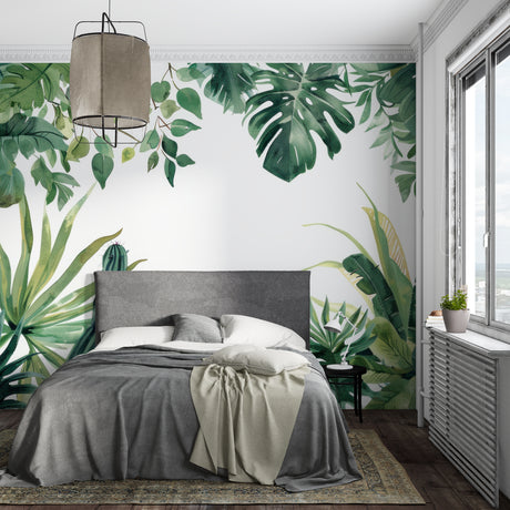 Bright Monstera leaf wallpaper in modern living room with white sofa and natural light