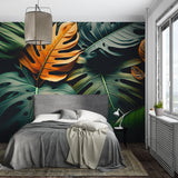 Home office featuring dramatic Monstera leaf wallpaper in orange and green tones
