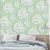 Modern living room featuring Monstera leaf wallpaper in white and mint green, creating a fresh botanical atmosphere