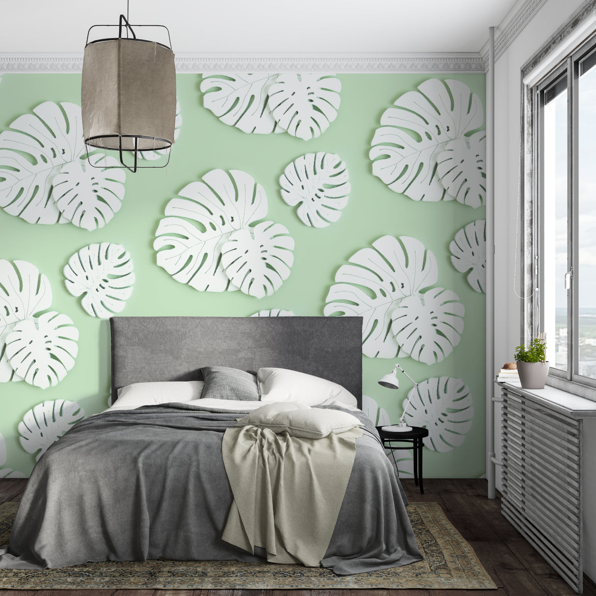 Bedroom styled with mint green Monstera wallpaper creating a calm, natural environment