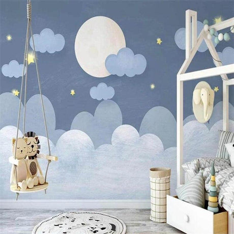 Moon and stars wallpaper in a cozy nursery with soft lighting showing the dreamy night sky design