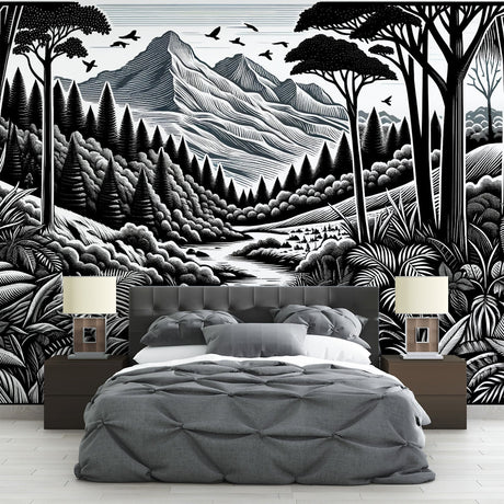 Black and white mountain forest wallpaper mural creating a dramatic focal point in a modern living room with minimal furniture