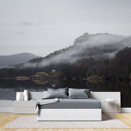 Mountain lake wallpaper creating depth in modern living room with grey sofa and natural light