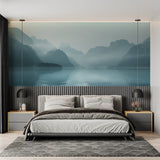 Mountain lake wallpaper creating depth in modern living room with grey sofa
