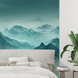 Turquoise mountain wallpaper in minimalist bedroom setting with white bedding