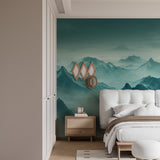 Mountain landscape mural in home office with wooden desk and plant accessories