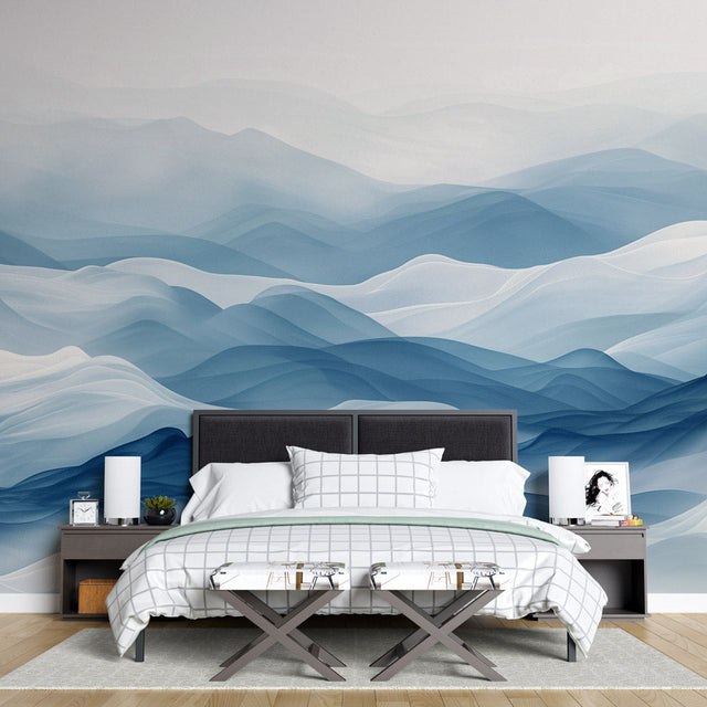 Mountain wall mural in modern living room showing blue abstract waves creating depth against white furniture