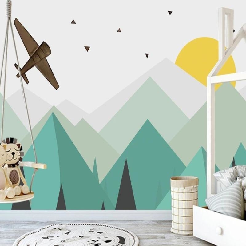 Geometric mountain wallpaper creating depth in modern nursery with mint and turquoise tones