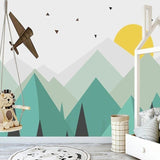 Geometric mountain wallpaper creating depth in modern nursery with mint and turquoise tones