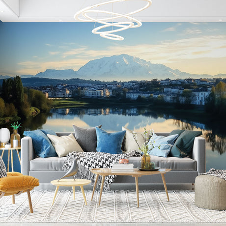 Mountain wall mural in modern living room showing snowy peaks and lake reflection creating depth and space