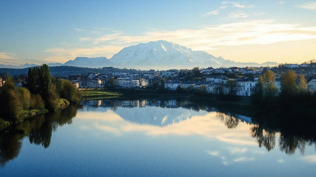 Mountain landscape wallpaper design file showing detailed alpine peaks and mirror lake reflection at dawn