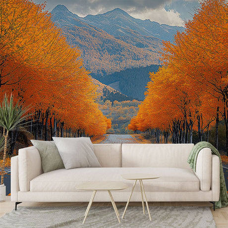 Mountain landscape wallpaper with autumn forest road shown in modern living room, warm orange tones complement contemporary furniture