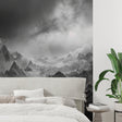Mountain peak wallpaper creating drama in modern living room with grey sofa and minimal decor