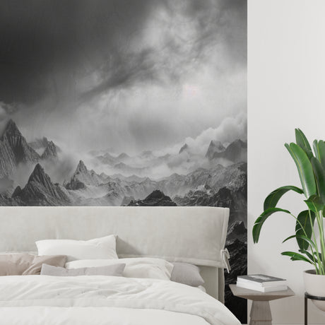 Mountain peak wallpaper creating drama in modern living room with grey sofa and minimal decor