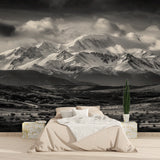 Mountain landscape wallpaper creating depth in a minimal living room setting