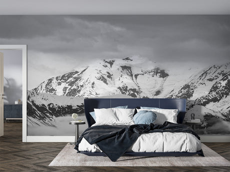 Mountain wall mural creating depth in modern living room with grey sofa and natural light