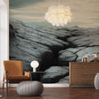 Mountain landscape wallpaper creating depth in a modern living room with grey sofa and natural lighting
